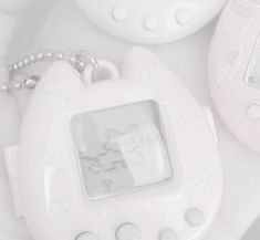 two baby pacifiers sitting next to each other on top of a white surface