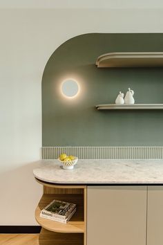 a kitchen counter with two white vases on top of it and shelves above the counter