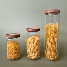 three glass jars filled with pasta and noodles