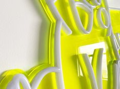 a neon green and white wall mounted light fixture with the word do it yourself on it