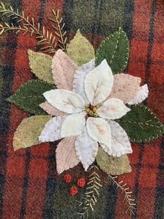 a christmas poinsetti on a plaid background