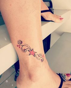 a woman's foot with a star tattoo on it