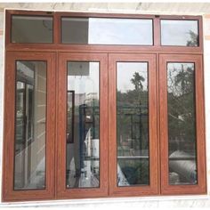 an image of wooden doors with glass on the outside and side windows in front of them