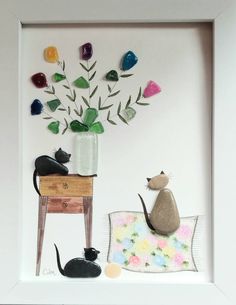 a cat sitting on top of a wooden table next to a vase filled with flowers