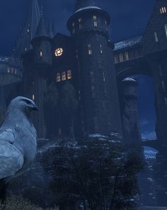 a large white bird standing in front of a castle at night with the lights on