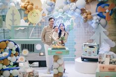 a man and woman standing in front of a cake