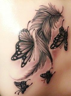 a woman's back with butterflies on it and the bottom part of her stomach