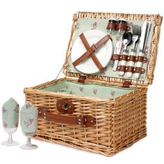 a wicker picnic basket with utensils in it