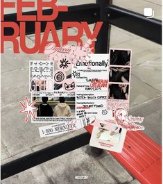 a red bench sitting on the side of a street next to a sidewalk with stickers all over it