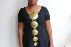 Brass necklace, Brass pendant, Brass jewelry, African women jewelry, Gift for her, African shaped brass necklace, Boho necklaceThis necklace is made of pure brass.It makes you stands out in any occassion.This can be a perfect gift for your loved ones. An outstanding piece of African handmade brass metal necklace made of a horizontal row of brass discs. Elegant and superbly crafted. #wakandaforever* brass metal* length of hanging pendant - 17inches/43cms* neck width - 16 inches/41cms We offer who African Beaded Bracelets, Jewelry Long Necklace, Blue Beaded Earrings, African Accessories, African Earrings, African Necklace, Mixed Metal Jewelry, Metal Necklace, Handmade Brass