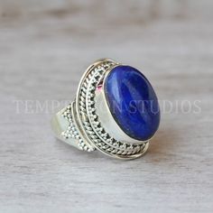 Natural Lapis Lazuli Ring, Cute Sterling Silver Ring,  Statement Ring, Alternate Engagement Ring, Chic Jewelry Your ring is made with pure sterling silver > Gemstone Type - Natural Lapis Lazuli > Gemstone Cut -  Oval Cabochon > Gemstone Size - 15 * 20 mm ✓ High quality materials ✓ Ethically sourced gemstones ✓ Nickel free ✓ Hassle free returns and refunds (T&C apply) ✓ Cancellations within 24 hours of purchase. ✓ Customer service available 365 days. Answers within a few hours.  >> More than 30 varieties of gemstones available in different sizes. >> Would love to customize/ personalize your order >> Engraving can be done at some extra cost.  >> Standard shipping : 10-12 working days. >> Express Shipping ($30) : 3-7 working days.  ✓ insured ✓ Securely packed ✓ Tracking available   Since I us Classic Lapis Lazuli Jewelry Ring, Classic Lapis Lazuli Ring As Gift, Classic Lapis Lazuli Ring As A Gift, Adjustable Lapis Lazuli Gemstone Ring, Round Lapis Lazuli Cabochon Rings, Stamped 925 Round Lapis Lazuli Jewelry, Lapis Lazuli Cabochon Rings, Handmade Lapis Lazuli Ring, Lapis Lazuli Gemstone Rings As Gift