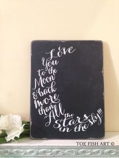 a chalkboard with the words i love you to the moon and back written on it