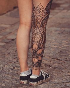 a woman's legs with tattoos on them