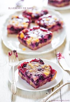 blueberry pie bars on white plates with forks