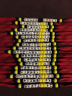 beads are arranged in the shape of a cross on a red and black table cloth