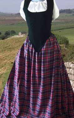 Majestic Velvets Costumes.  4 pc. Scottish dress: velvet bodice, plaid skirt, hoop, and cotton chemise (short or long sleeve, drawstring neckline, hip length).  The velvet bodice has side lacing w/ 20 grommets (laces on both sides) and modestly panels for expandability, 10 bones or stays (6 down front, 4 on sides), and lined w/ thick cotton canvas-like fabric.  Skirt is poly/cotton blend plaid, 115" circumference at bottom. Black w/ red plaid, or Hunter w/ navy & green plaid. Outlander Fashion, Steampunk Costumes, Irish Dress, Celtic Festival, Tartan Fashion