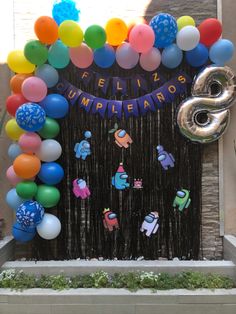 balloons and streamers decorate the entrance to a children's birthday party