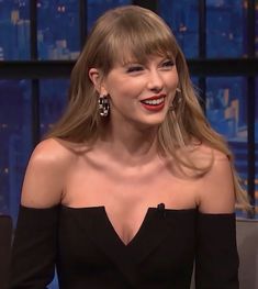 taylor swift on the tonight show wearing an off - shoulder black dress and red lipstick