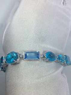 This Blue Topaz and Blue Quartz bracelet is very lively and bright. The stones are deep colors and different tones of blue The sterling silver is plated with rhodium to protect the bracelet from tarnish and give the appearance of white gold. 8 inches All jewelry is shipped in a nice gift box. Check out our over a THOUSAND great reviews Engraving is $4 per letter and is not always perfect depending on the piece. It can take a few days if the jeweler is busy. This is payable to Paypal Judithsltd@g Modern Blue Multi-stone Jewelry, Luxury Blue Gemstones With Accents, Luxury Blue Sterling Silver Bracelet For Formal Occasions, Elegant Turquoise Multi-stone Bracelets, Luxury Blue Gemstone Sterling Silver Bracelet, Elegant Blue Faceted Bracelets, Formal Blue Gemstone Bracelets, Blue Gemstones With Accents Fine Jewelry, Blue Gemstone Bracelets In Fine Jewelry Style