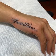 a person's hand with a tattoo that says persuence on it and the word persutive in cursive writing