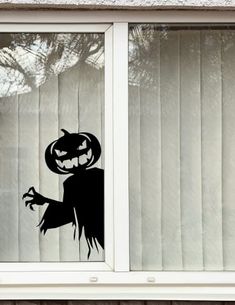 an image of a window decorated for halloween with a jack - o'- lantern on it