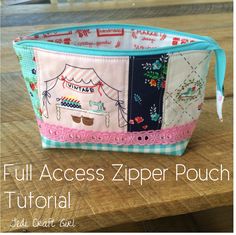 a small zipper pouch sitting on top of a wooden table with the words full access zip pouch