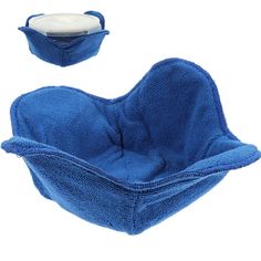 a blue bathtub with a white lid and cover on it's side, next to a small bowl