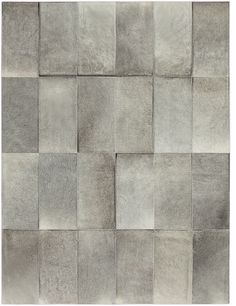 an area rug made out of squares and rectangles in various shades of grey