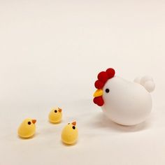 a chicken and her chicks are shown on a white background with three smaller ones in the foreground