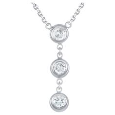 Make your everyday style sparkle with this three-stone diamond necklace. This 14K white gold necklace features a diamond trio pendant with three round bezel-set diamonds suspended vertically from a dainty chain. A lobster clasp secures the necklace in place. This LB Exclusive 14K White Gold 0.45ct Diamond 3-Stone Necklace is offered brand new inclusive of a gift box. Luxury Silver Three Stone Necklaces, 3 Stone Pendant Necklace, 3 Stone Diamond Necklace, 3 Stone Pendant, Diamond Bar Necklace, White Gold Necklace, White Gold Set, Three Stone Diamond, Bezel Set Diamond