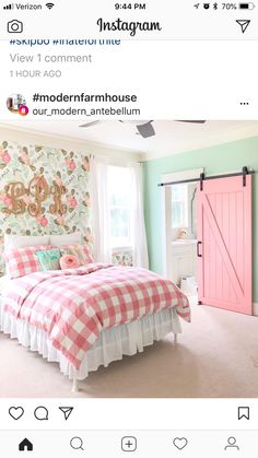 a pink and white bed sitting in a bedroom next to a window