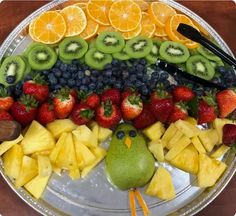 a platter filled with fruit, kiwi and oranges