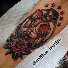 a tattoo on the leg of a man with boxing gloves and flowers in his hand