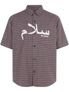 a shirt with arabic writing on the chest and white letters on the front, in black and