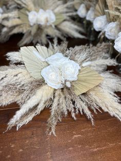 some white flowers and feathers on a table