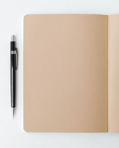 an open notebook with a pen on top