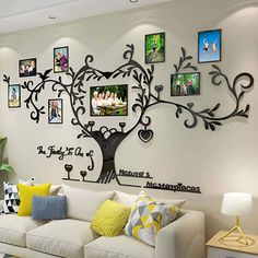 a living room with white couches and pictures on the wall