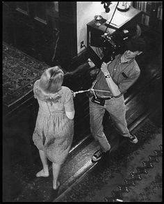 an old black and white photo of two people in front of a television camera on a tripod