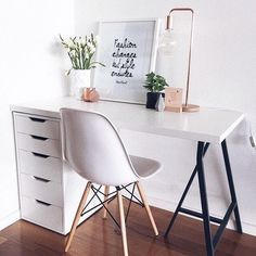 a white desk with two chairs next to it and a potted plant on top