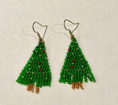 This is a beautiful glossy pair of earrings that's perfect to give your family and friends as a Christmas gift . These earrings are made with 11/0 transparent green seed beads, golden , and red seed beads  Please message me if you want earrings with different length or color . Thanks for visiting. Colorful Beads Christmas Earrings Gift, Christmas Gift Earrings With Colorful Beads, Colorful Beads Earrings For Christmas Gift, Festive Gold Beaded Earrings, Handmade Gold Beaded Earrings For Christmas, Gold Beaded Dangle Earrings For Gifts, Gift Gold Beaded Earrings, Christmas Gold Beaded Earrings, Holiday Beaded Earrings As Gift