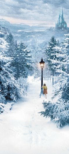 a person walking down a snow covered path with a street light in the middle of it