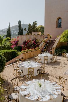 an outdoor dining area with tables and chairs set up for formal function in the sun