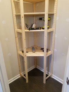 a wooden shelf with tools on it in a room