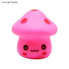 a pink mushroom with black dots on it's face and eyes, sitting in front of a white background