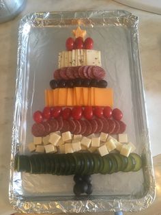 a christmas tree made out of cheese, meats and veggies on a tray