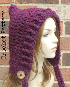 a mannequin head wearing a purple knitted hat with buttons on the side