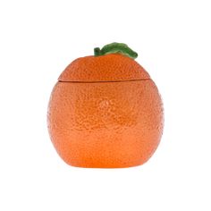 an orange sitting on top of a white surface