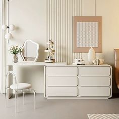 a white dresser sitting next to a brown chair