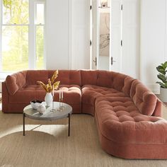 a living room with a sectional couch and coffee table