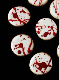 some cookies with red and white icing on them